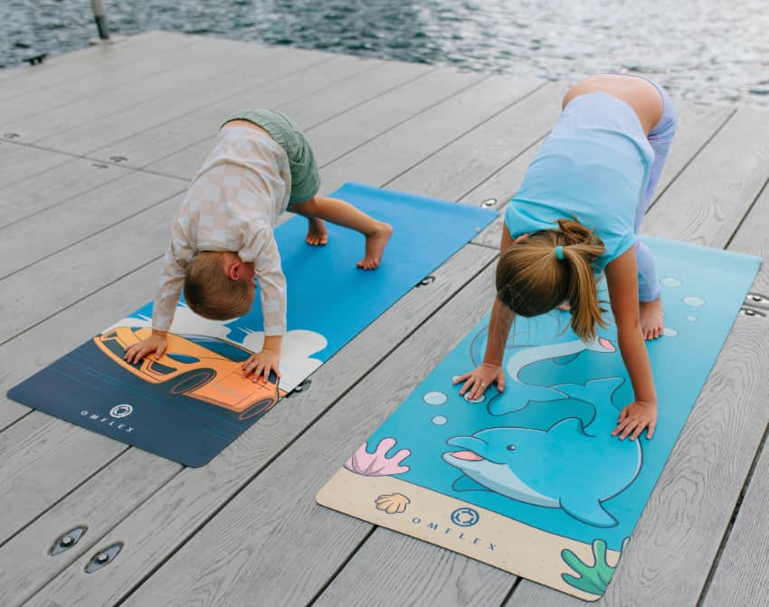 2 kids doing yoga on Omflex Car & Dolphin yoga mats.