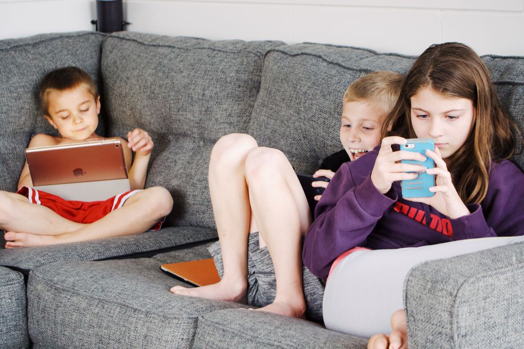 Three kids sitting on the sofa on screens