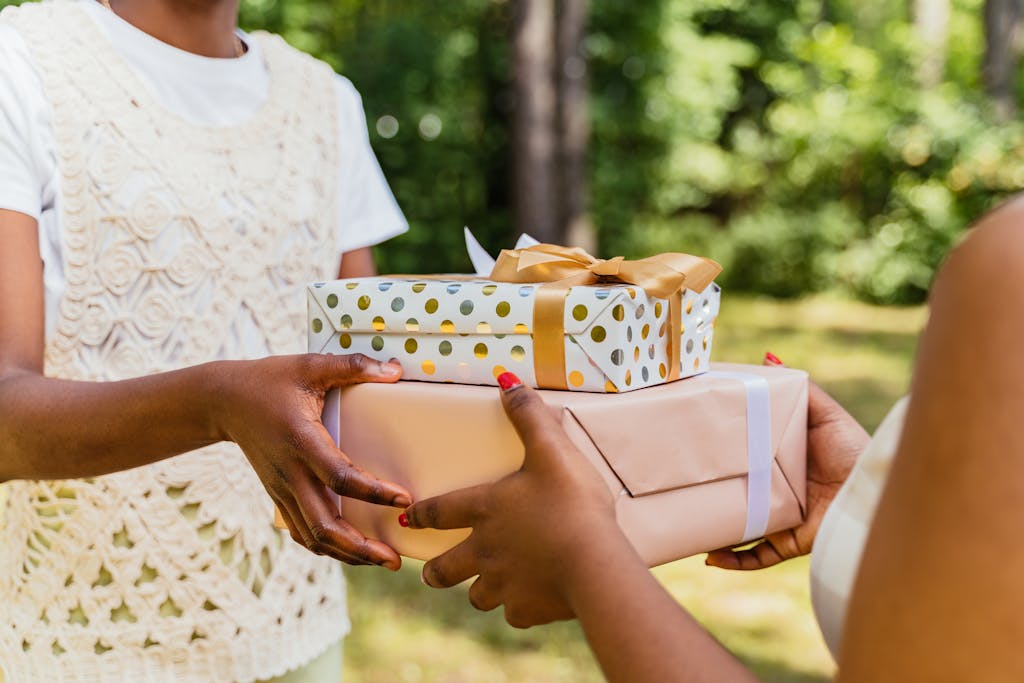 Two people holding gifts together