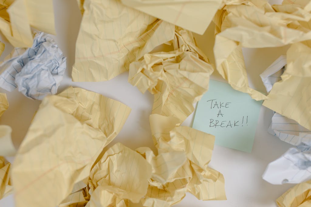 Crumpled papers and a post-it note that say Take A Break!!